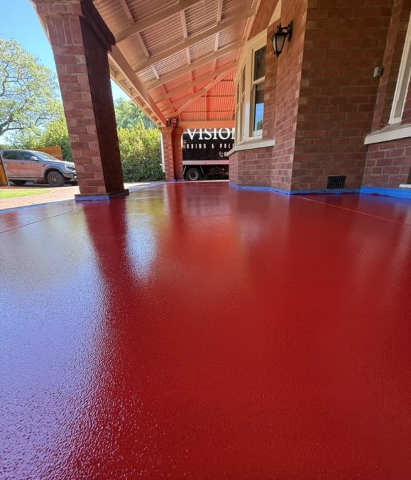 Red epoxy flooring installed on a residential verandah with a slip-resistant finish Adelaide